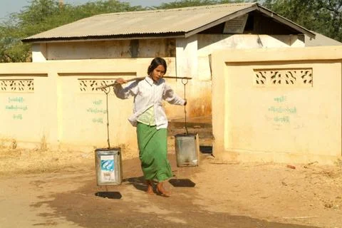 Young man carrying water at the village of  Minnanthu Stock Photos