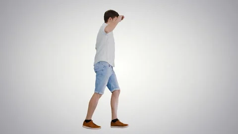 Young man in casual clothes dancing happily while walking on gradient background Stock-Footage 140528651