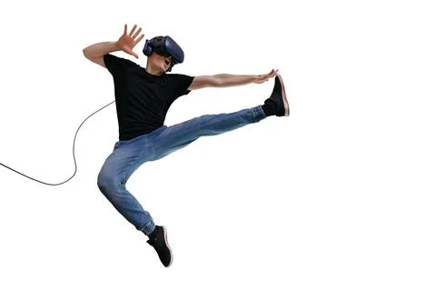 Young man in casual clothes using VR headset for playing game and imagin himself Stock Photos