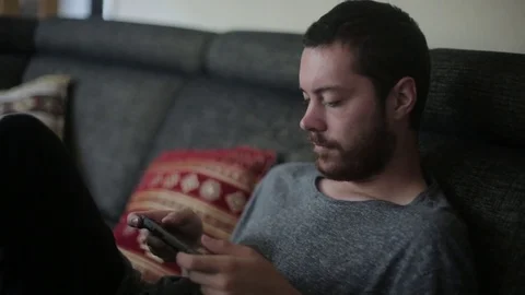 Young Man Casually Playing Portable Video Game Console Stock Footage 76688429