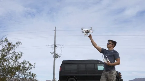 Young man catching drone out of the sky Stock Footage 111311404