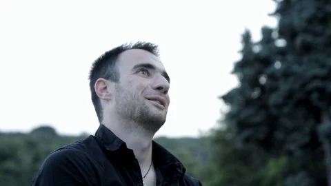A young man Caucasian appearance in the park emotionally talking Stock Footage 114317536