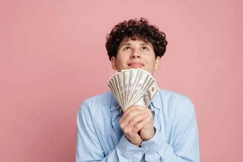 Young Man Celebrating Financial Success with Cash in Hands Stock Photos