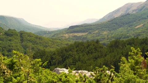 Young man celebrating at a mountain summit, Croatia. Video stock 118087380