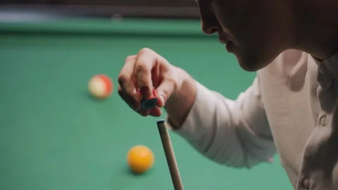 Young Man Chalks Cue Stick Before Shot on Green Pool Table 스톡 동영상 304968272