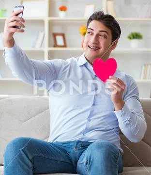 Young man chatting with his sweetheart over mobile phone Stock Photos