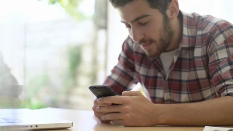 Young man chatting on smartphone Stock Footage 106293658