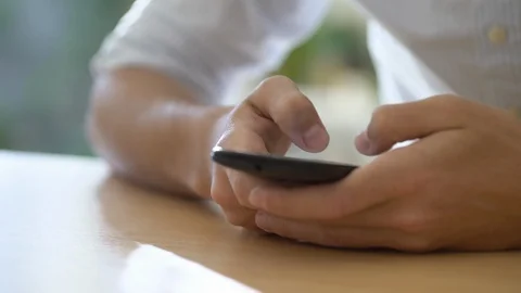Young man chatting on smartphone Stock Footage 106294247
