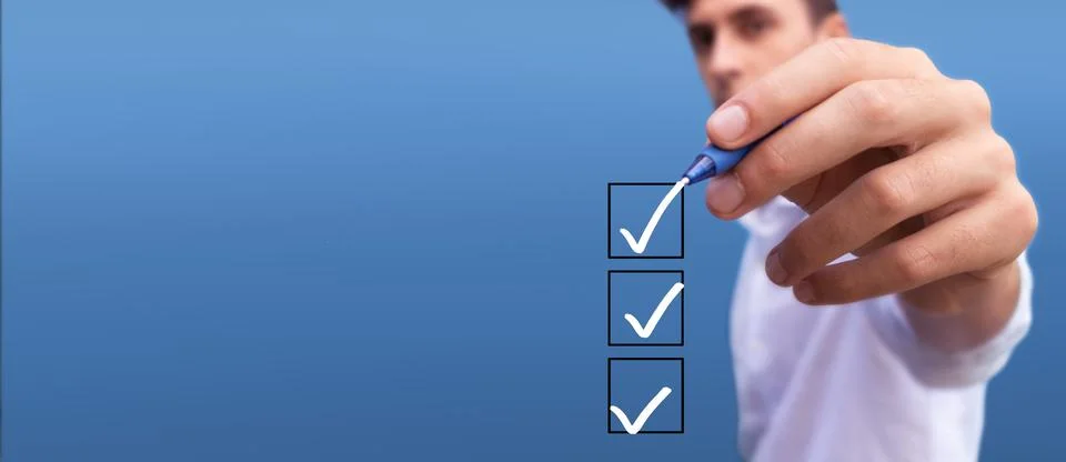 Young man checking boxes with list of 3 options on blue background Stock Photos