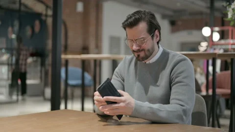 Young Man Checking Empty Wallet in Office Stock Footage 161318729