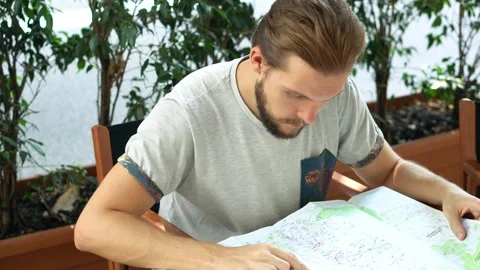Young Man Checking Map Outdoors Table Stock Footage 131353677