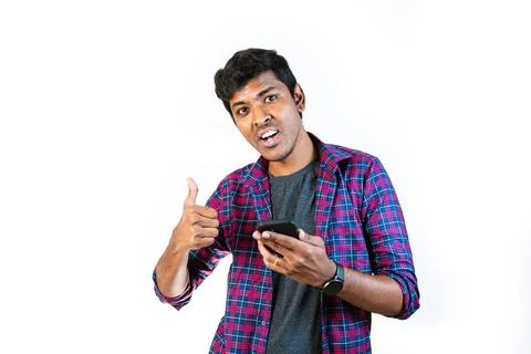 Young Man Checking Mobile Phone and Giving Thumbs Up Stock Photos