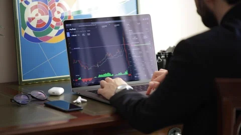 A young man checking the stock prices on his laptop. Business man concept Stock Footage 129303592
