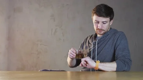 Young Man Checks Hour on his Watch and Leaves Stock Footage 69172653