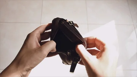 Young man checks a wallet in which there is no money and throws it on the floor  Stock Footage 125553642