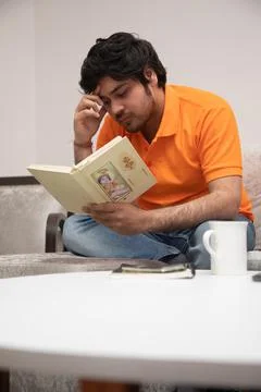 Young Man Chilling on Sofa Stock-Fotos