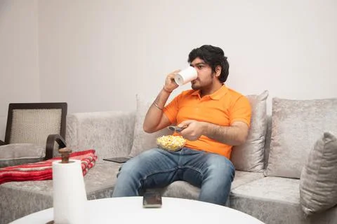 Young Man Chilling on Sofa Stock-Fotos