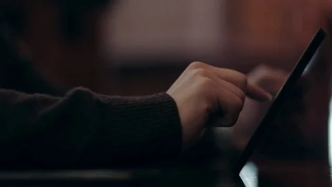 The young man chooses items in the online store using the tablet. Video stock 71565795