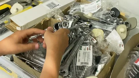 Young man chooses a tool in the store. Wrench in hands close up Stock Footage 204972858
