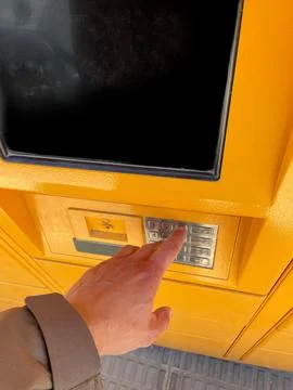 Young man choosing the automatic parcel machine operation 스톡 사진