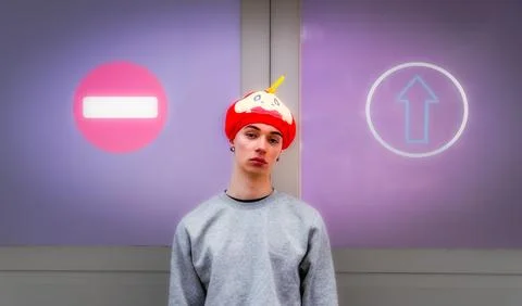Young man choosing between no entry and one-way signs Stock Photos