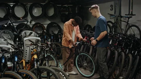 Young Man Choosing New Bicycle in Local Store Stock Footage 321043383