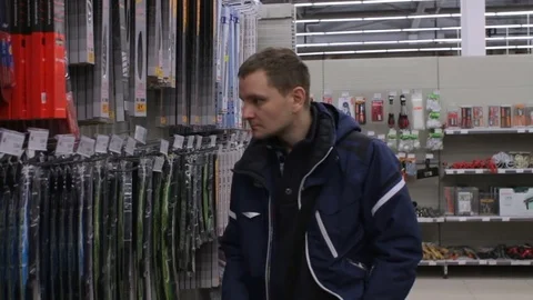Young man is choosing windshield wipers at the store Stock Footage 74434240