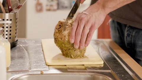 Young man chopping celery on a board Stock Footage 120710021