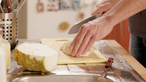 Young man chopping celery on a board Stock Footage 120710799