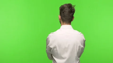 Young man on chroma from behind, looking back Stock Footage 97589595