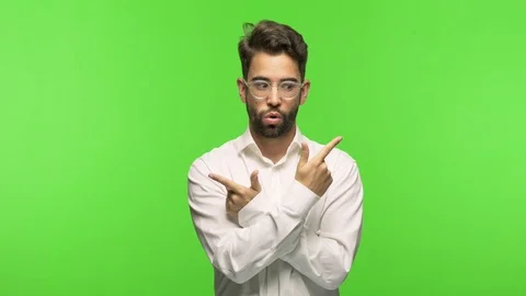Young man on chroma decide between two options Stock Footage 97588969