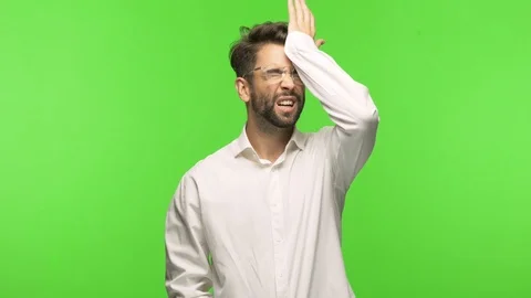 Young man on chroma forgetful, realize something Stock Footage 97588924