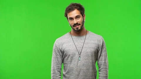 Young man on chroma green screen cheerful and with a big smile Video stock 97706096