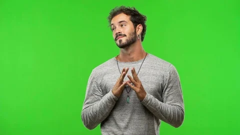 Young man on chroma green screen devising a plan Stock Footage 97706233
