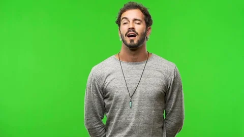 Young man on chroma green screen winking Video stock 97706390