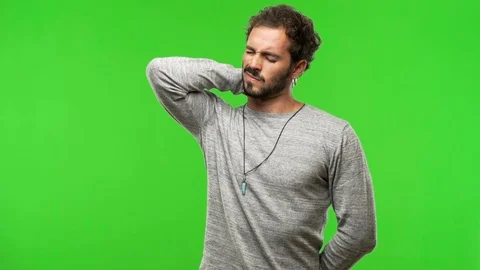 Young man on chroma green screen suffering neck pain Stock Footage 97706402