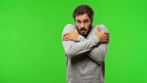 Young man on chroma green screen going cold Stock-Footage 97706503
