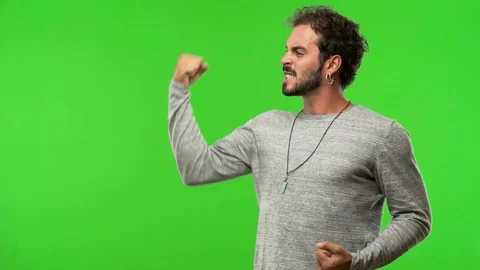Young man on chroma green screen who does not surrender Stock Footage 97706700