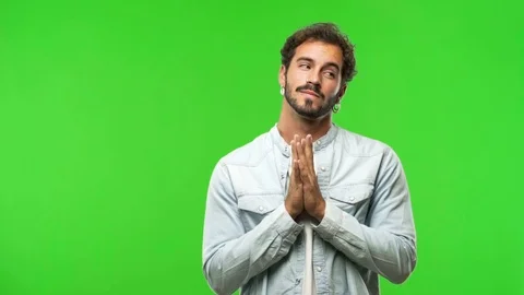 Young man on chroma green screen devising a plan Stock Footage 97707532
