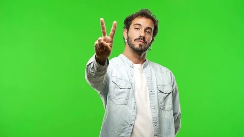 Young man on chroma green screen showing number two Stock-Footage 97708367