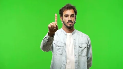 Young man on chroma green screen showing number one Stock Footage 97708394