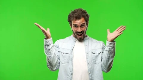 Young man on chroma green screen celebrating a victory or success Stock Footage 97708489