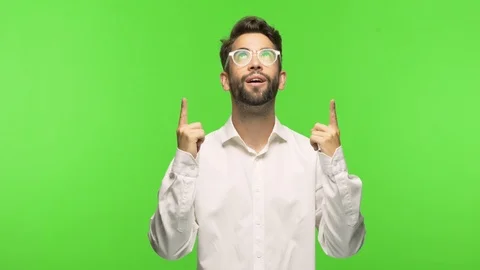 Young man on chroma pointing up Stock Footage 97589217