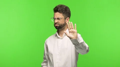 Young man on chroma putting hand in front Stock Footage 97588884