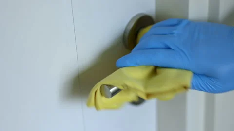 The young man cleaned the door locks by spraying cleaning agents to kill germs a Stock Footage 153930574