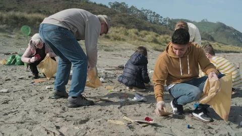 Young man cleaning the beach Stock Footage 144322515