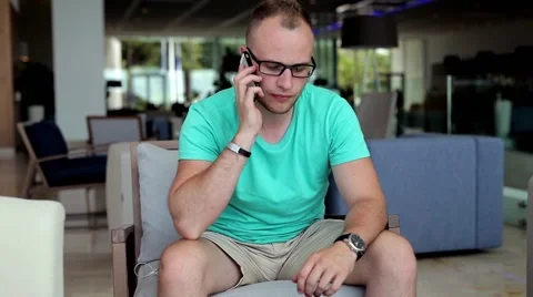 Young man cleaning glasses Stock Footage 54543825