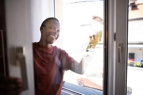 Young Man Cleaning Windows at Home Smiling at Camera Stock Photos
