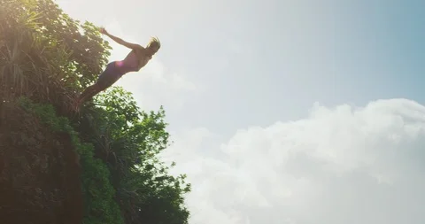 Young man cliff diving Stock Footage 105890132