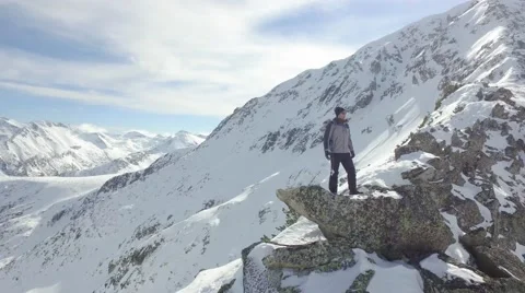 Young Man Climber Standing On Rock Edge Winter Mountain Peak Achievement Scenic Stock Footage